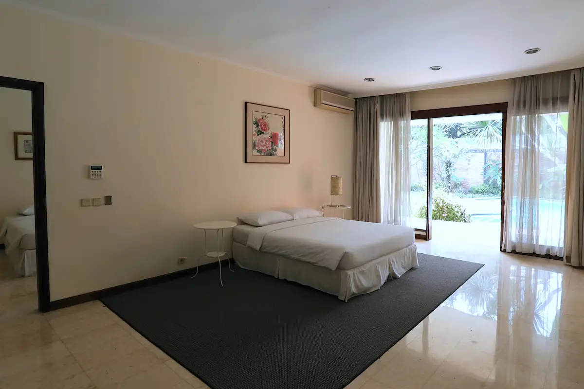 Master bedroom retreat with plush bedding and direct garden access